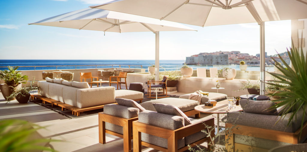 Exterior terrace with comfortable furnishings in neutral tones with view of the sea and Dubrovnik