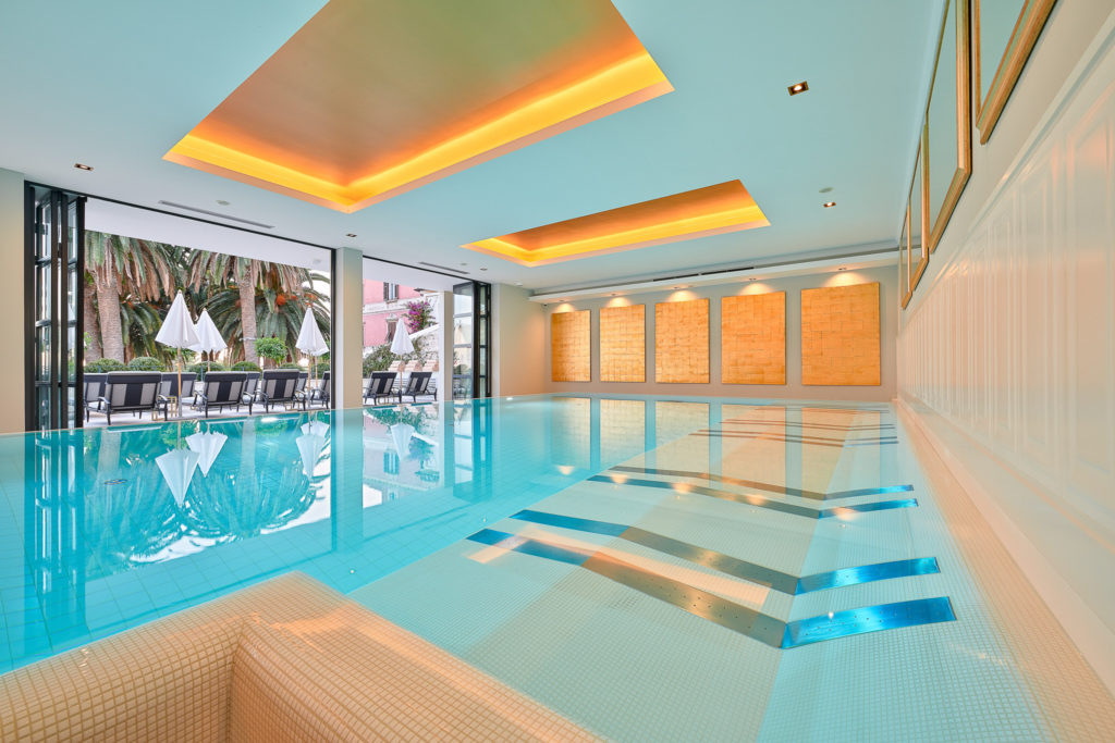 The indoor pool faces a wall of glass doors, opened like an accordion to allow the outside in