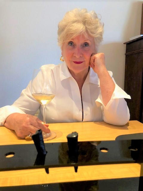 Wanda with a glass of white wine