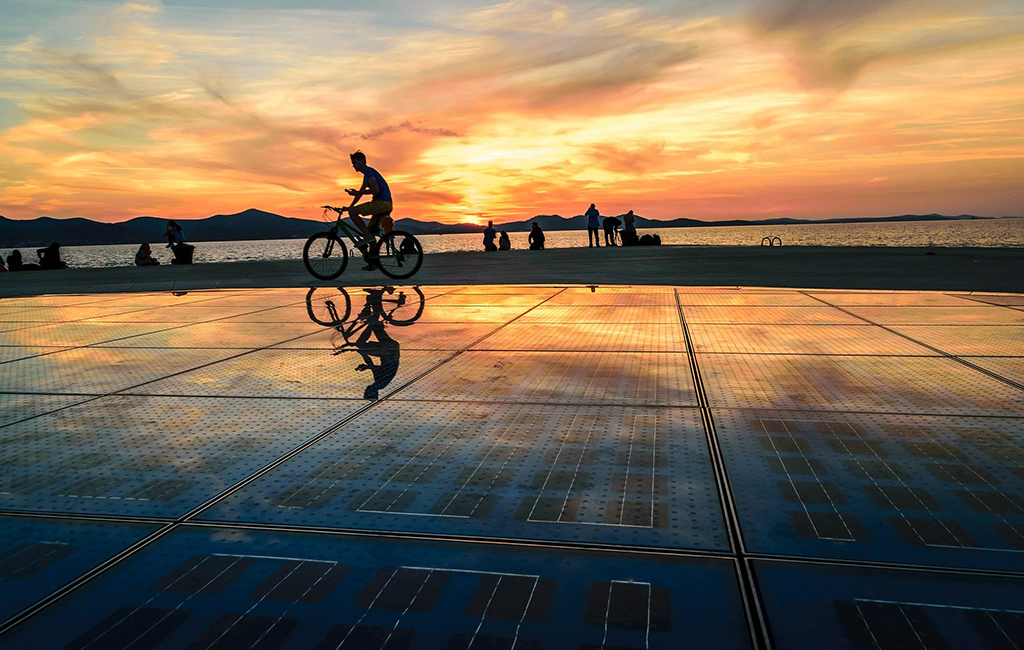 Sunset in Zadar, Croatia over Nikola Bašić's public artwork, "Greeting to the Sun." Tasteful Croatian Journeys' recommendation for where to visit in June. 